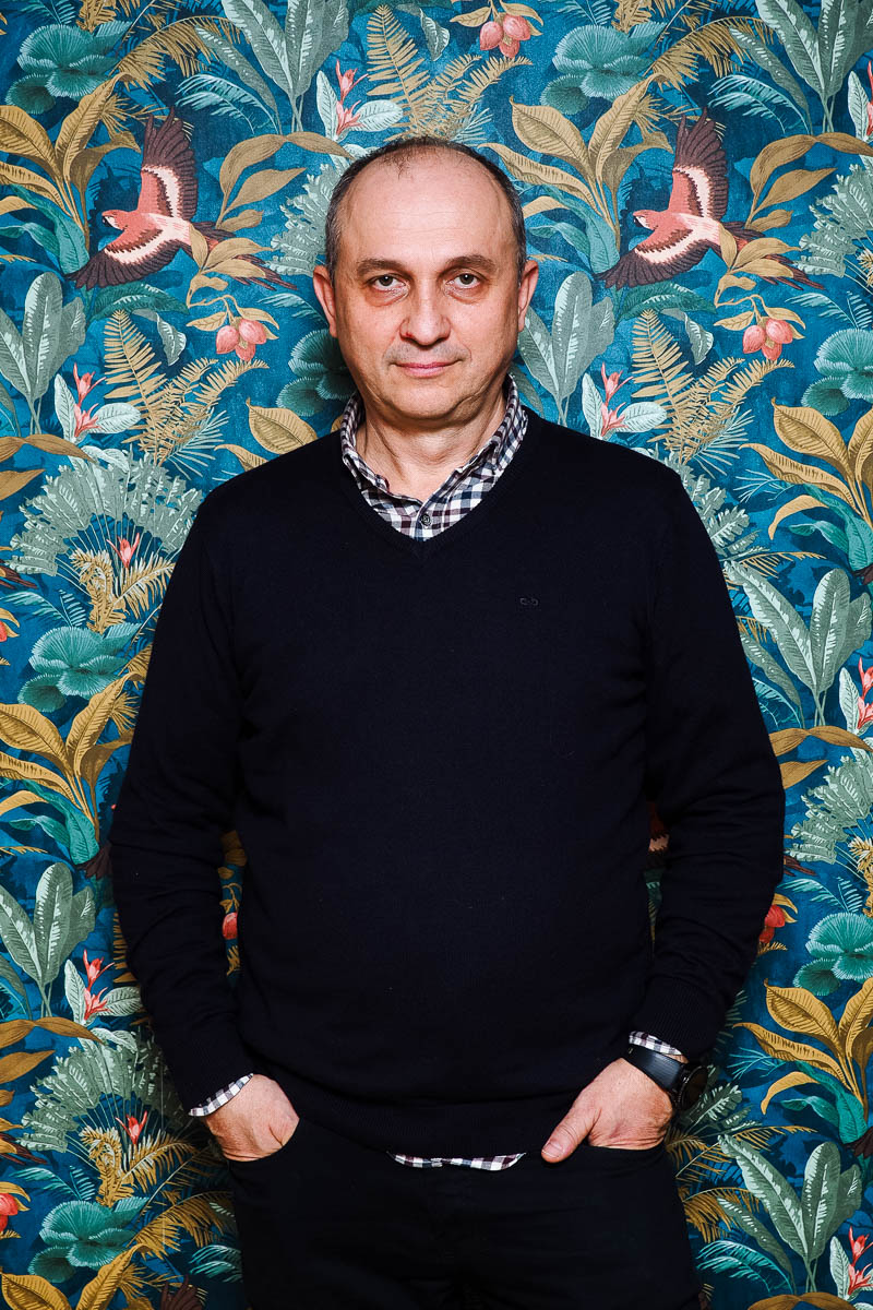 Portrait of Adnan, facing neutral in the camera, hands in purse wearing a black long sleeves.