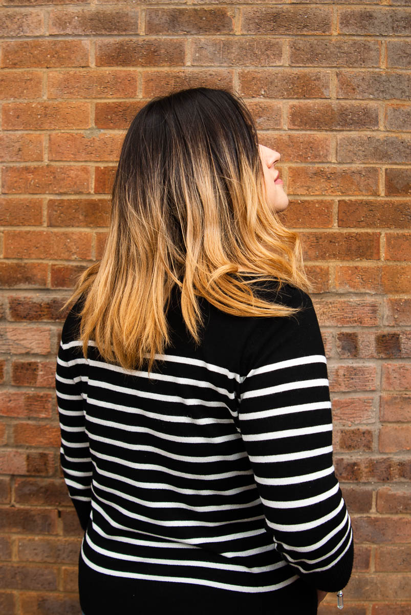 Portrait of refugee Sheri with her back towards the camera