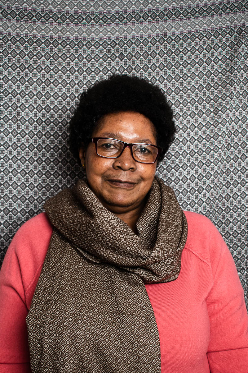 Portrait of refugee Immaculate with a brown printed scarf