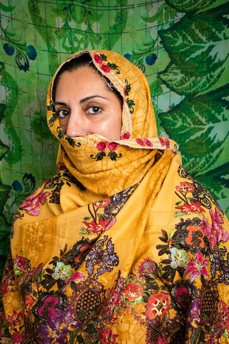 Portrait of refugee Robina, her face covered with a shawl