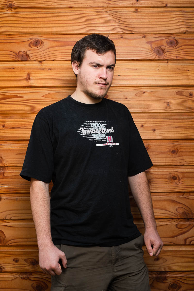 Portrait of refugee Viacheslav against a wooden plank background