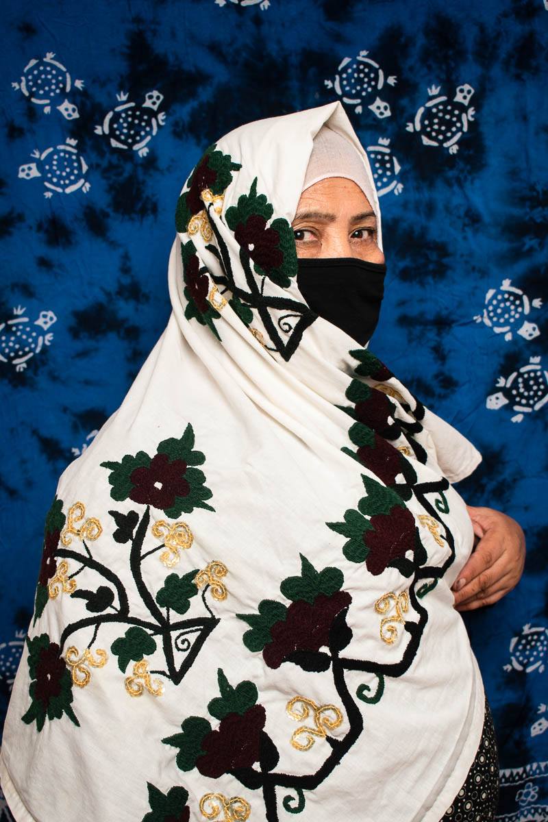 Portrait of refugee Mahtab with her face covered
