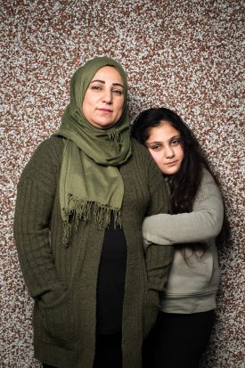 Portrait of refugee Dlbar hugging her mother