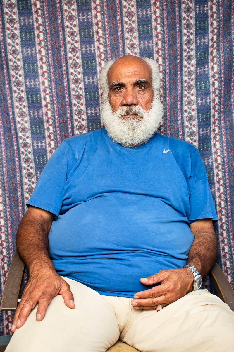 Portrait of refugee Hamuwd sitting and staring at the camera