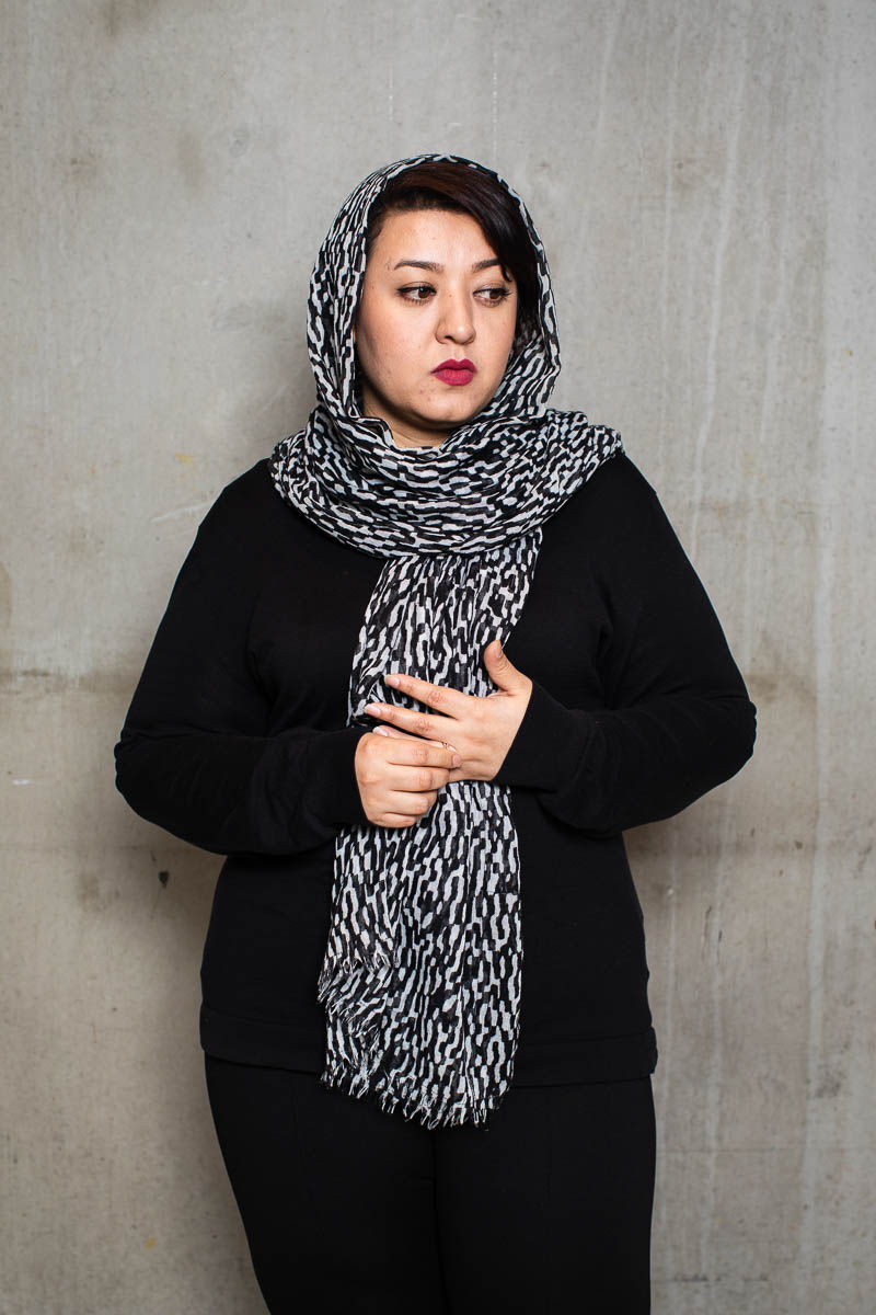 Portrait of refugee Zahra wearing a printed hijab