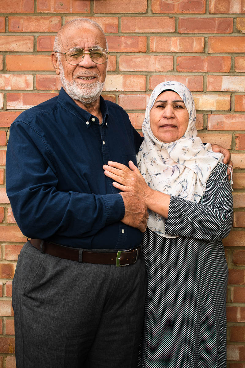 Portrait of refugee Ghanem holding their partner