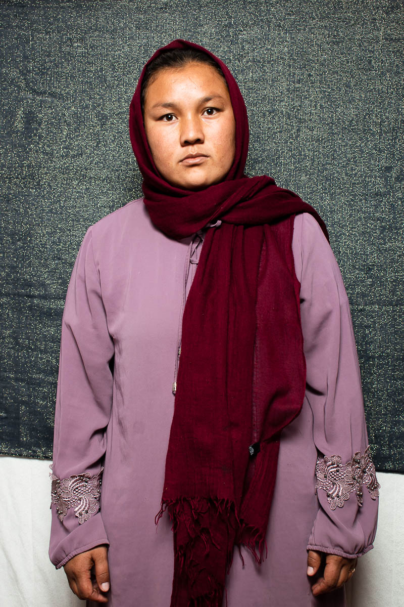 Portrait of refugee Sakine wearing a maroon hijab