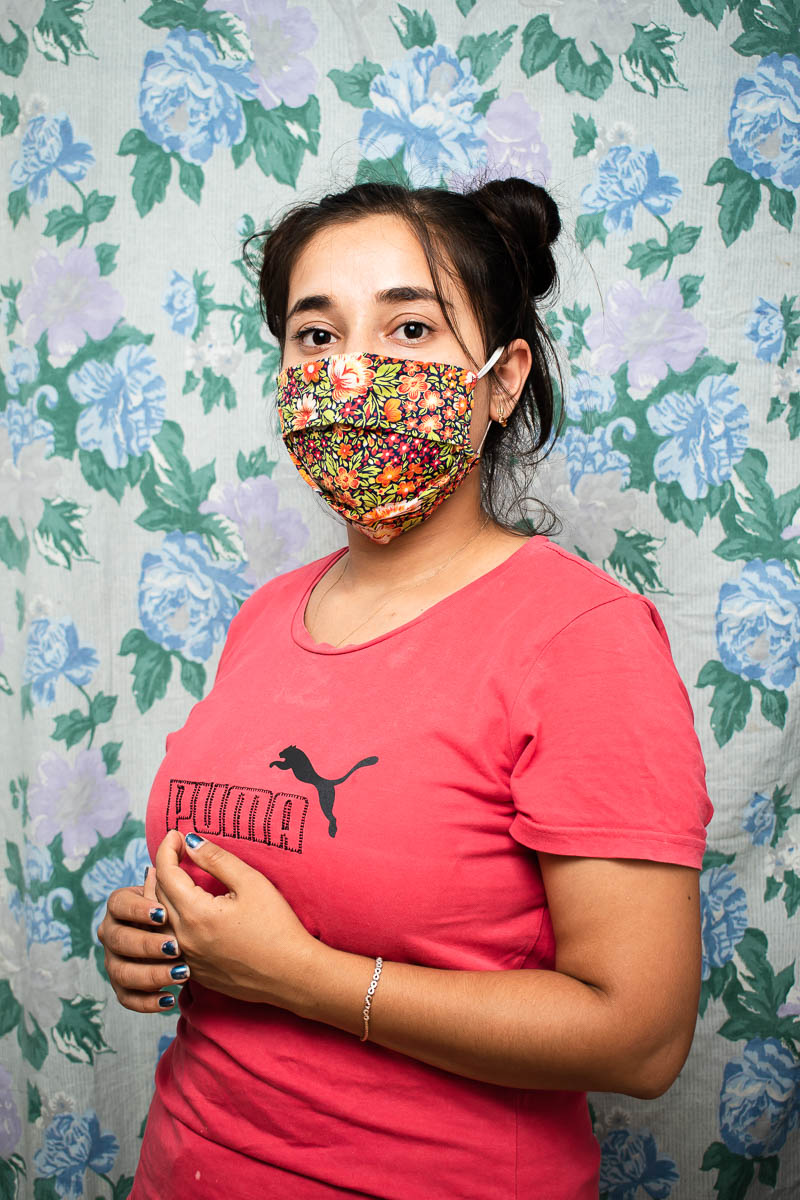 Portrait of refugee Maryam wearing a floral face mask