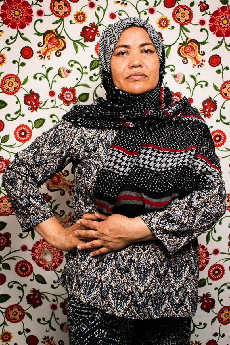 Portrait of refugee Sakine both her hands on her right side of her hip