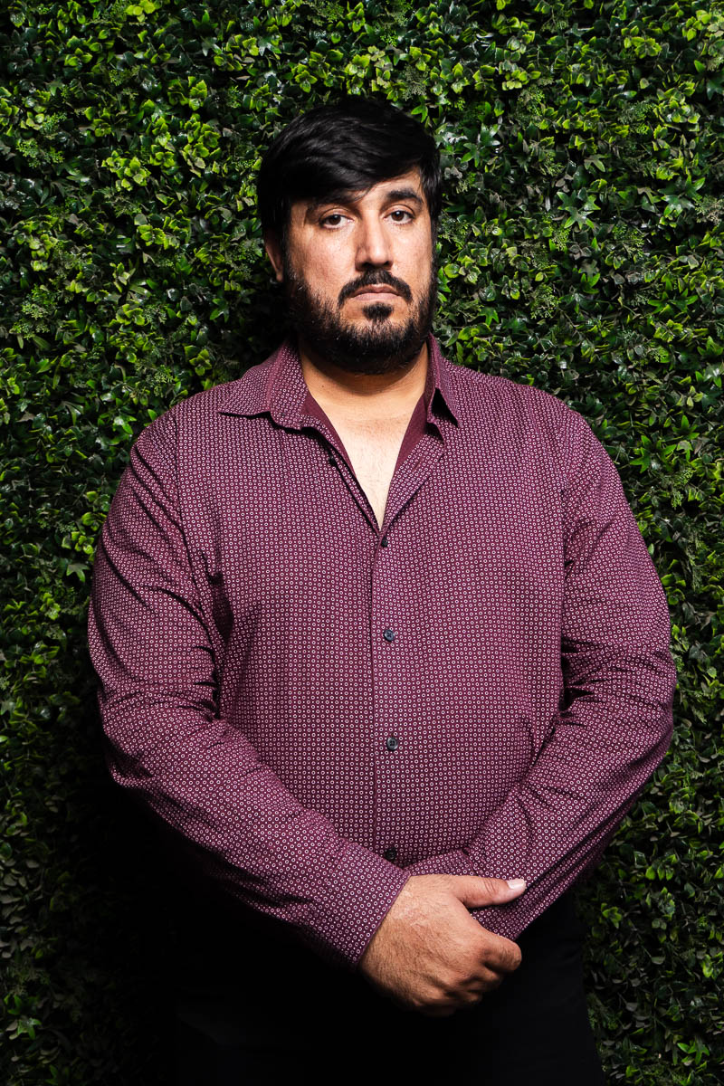 Portrait of Mohammad, facing neutral in the camera, wearing a maroon long sleeves.