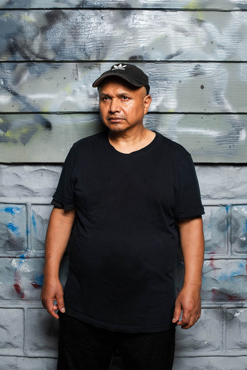 Portrait of Sergio, wearing a black shirt and a black cap.