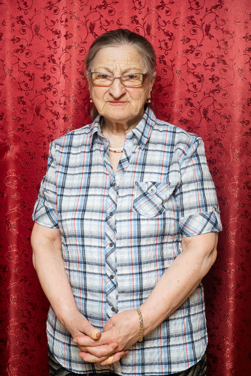 Portrait of Adila, wearing a checkered sleeves facing neutral in the camera.
