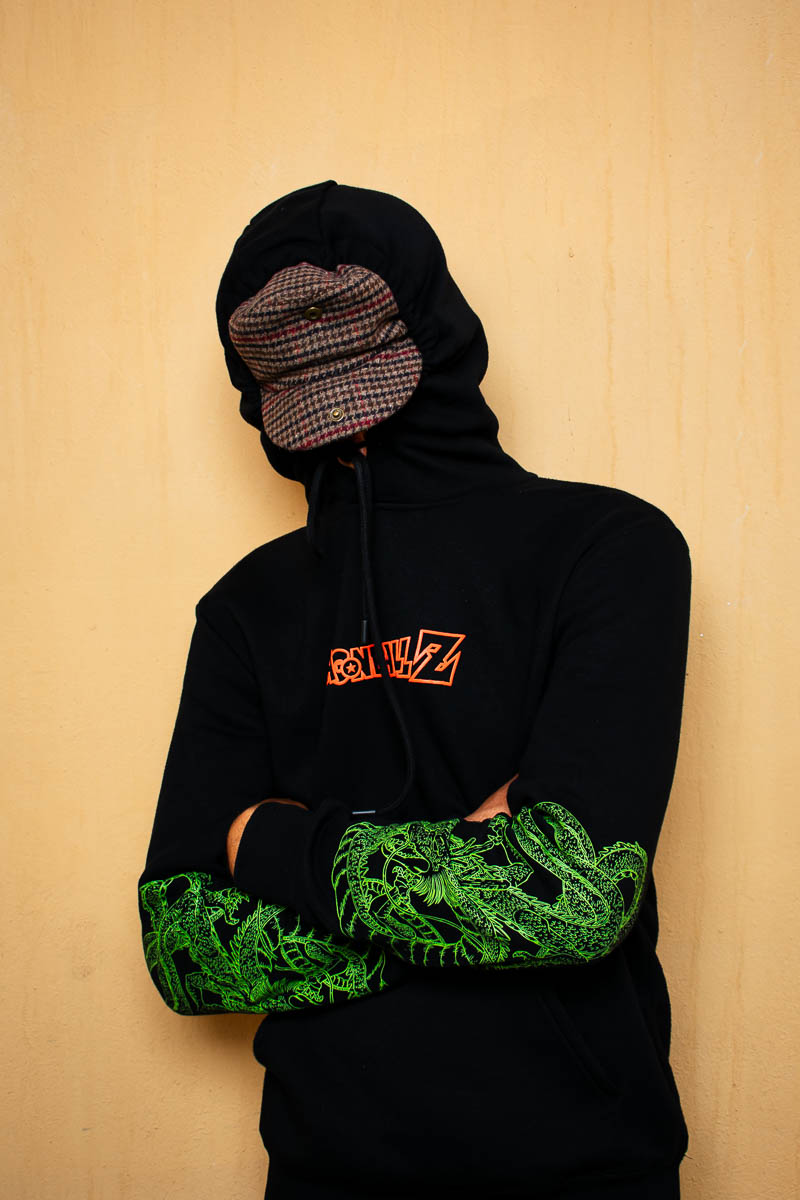 Portrait of Ismail, not showing his face in the camera and is wearing a black jacket and a cap.