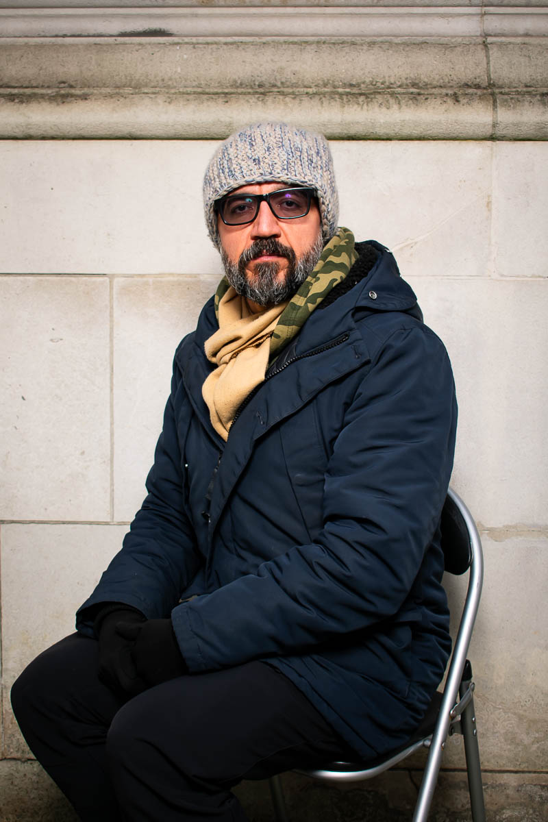 Portrait of Vahid, wearing shades facing the camera wearing a jacket.