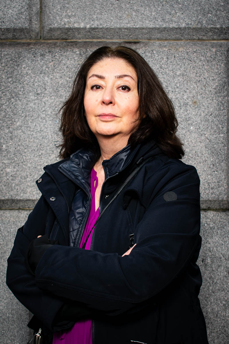 Portrait of Maryam, facing the camera wearing a black jacket and arms crossed together.