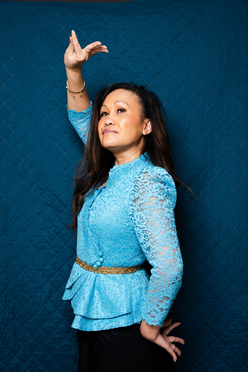 Portrait of Vanhny, facing sideward, wearing a shade of blue.