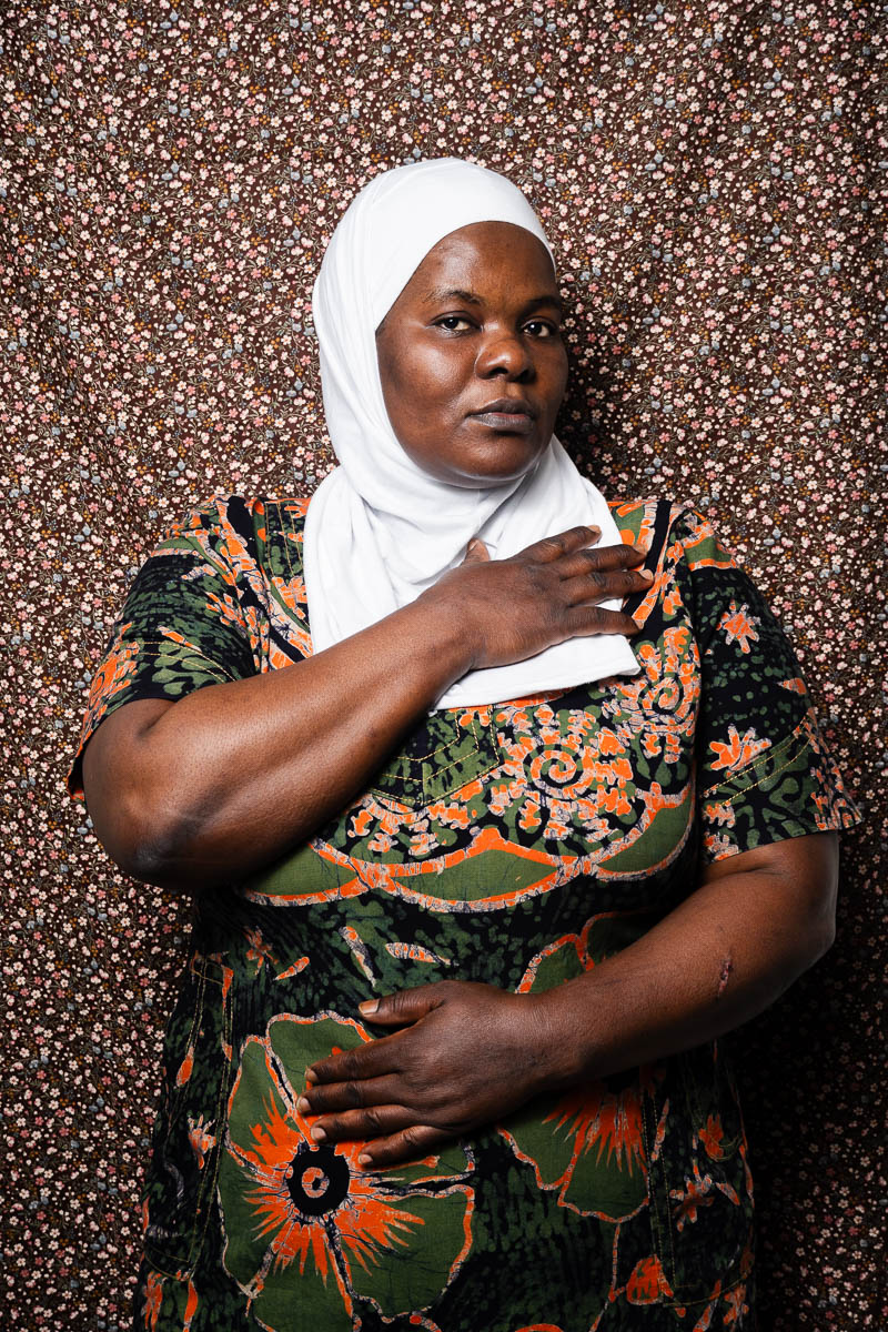 Portrait of Sumaih, wearing a whit hijab scarf and placed her left arm to her chest.