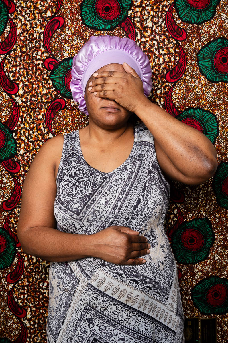 Portrait of Stella, covered her face using her hands.