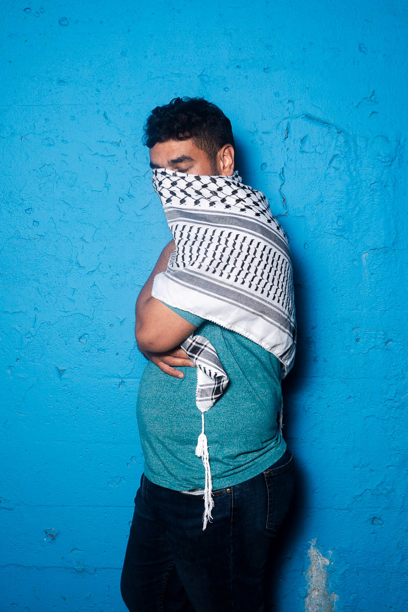 Portrait of Ahmed, covered hald of his face using a hijab scarf.