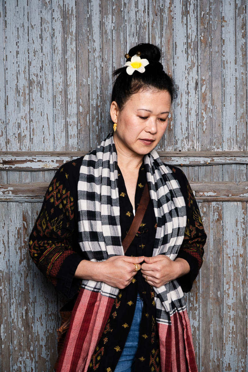 Portrait of Magnolia wearing black dress and a long scarf.