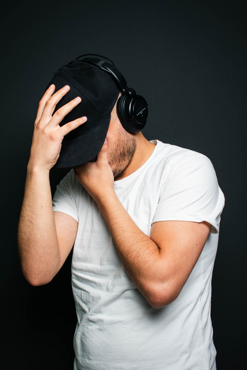 Portrait of Moe, hiding his face and is wearing a white shirt