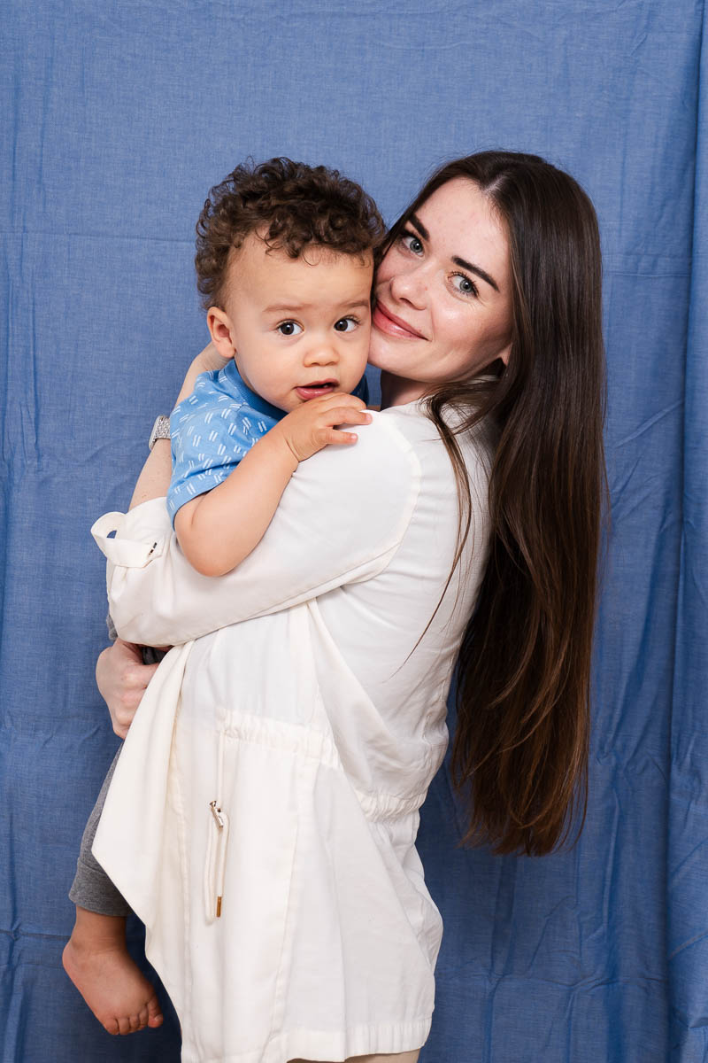 Portrait of Roksolana, smiling at the camera and is holding a baby.