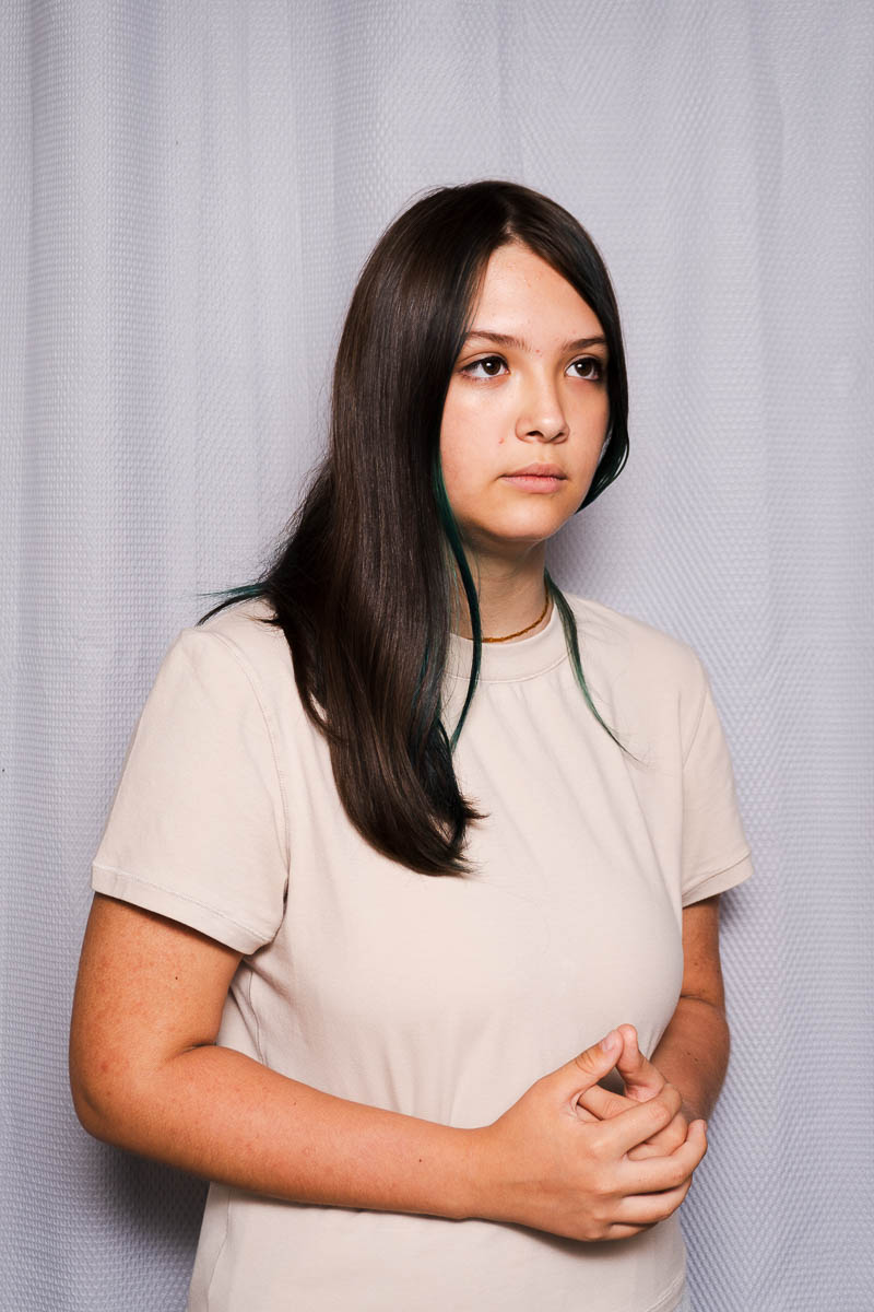 Portrait of Veronika, not facing directly in the camera and is wearing a white shirt.