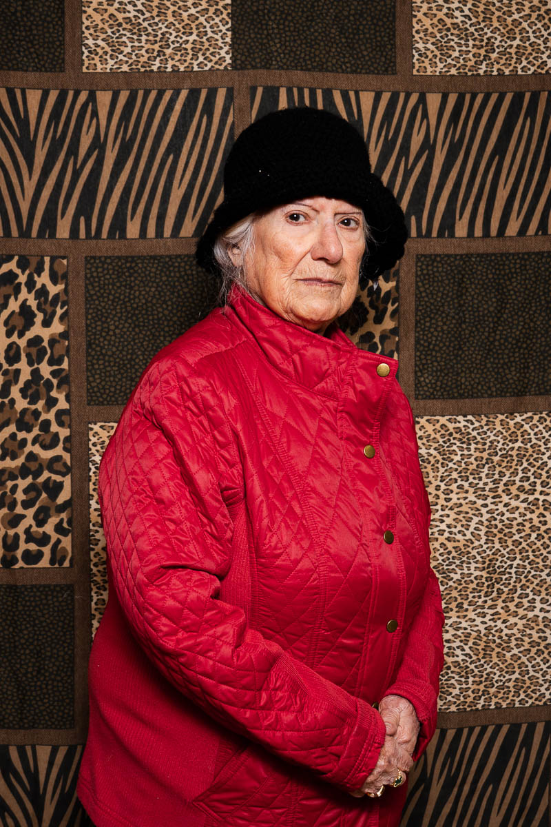 Portrait of Ameera, looking intently in the camera and is wearing a red sweater.